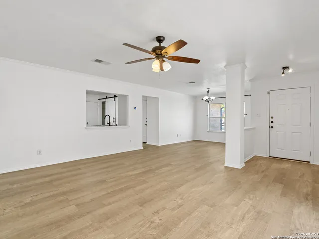 a view of a livingroom with a ceiling fan & a ceiling fan