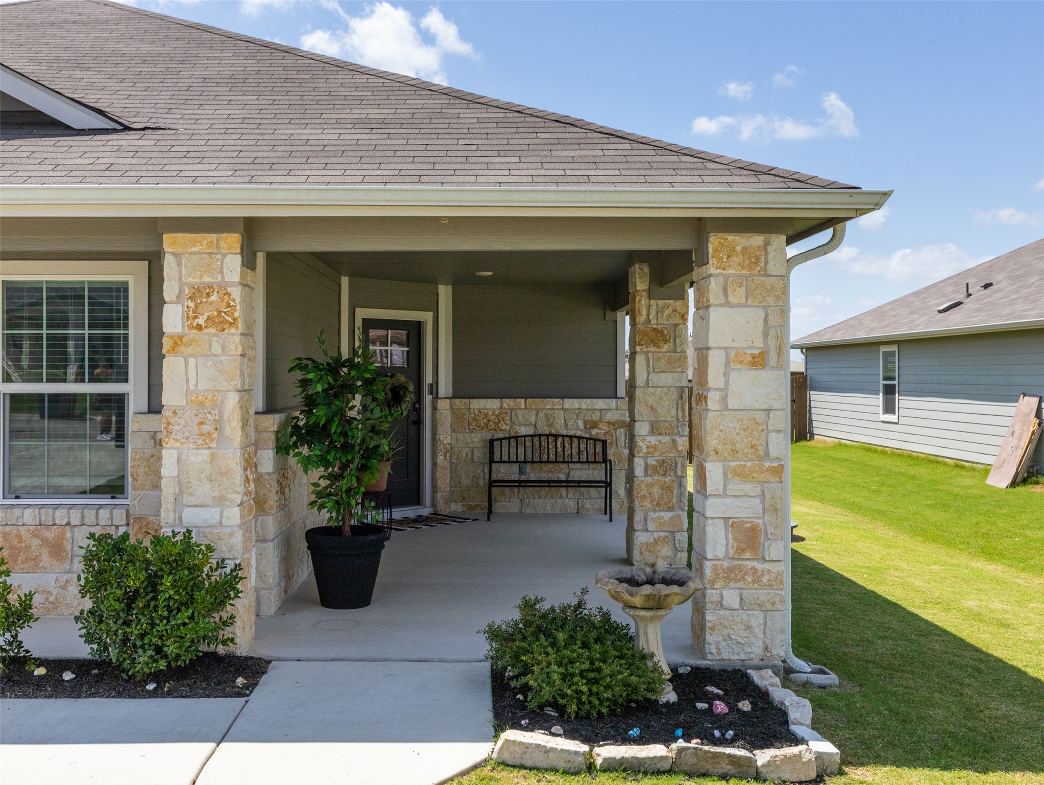 439 Hunter Loop Bertram, TX 78605 - Photo 3 of 23 Stone pillars define the inviting entrance to this charming residence, framed by manicured landscaping.