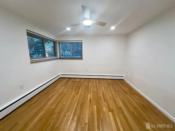 a view of a room with wooden floor and window