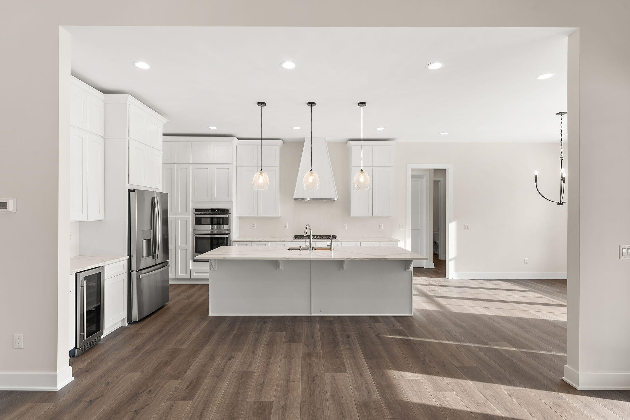 16669 Noble Street Lowell, IN 46356 - Photo 13 of 55 a view of kitchen with refrigerator stove and wooden floor