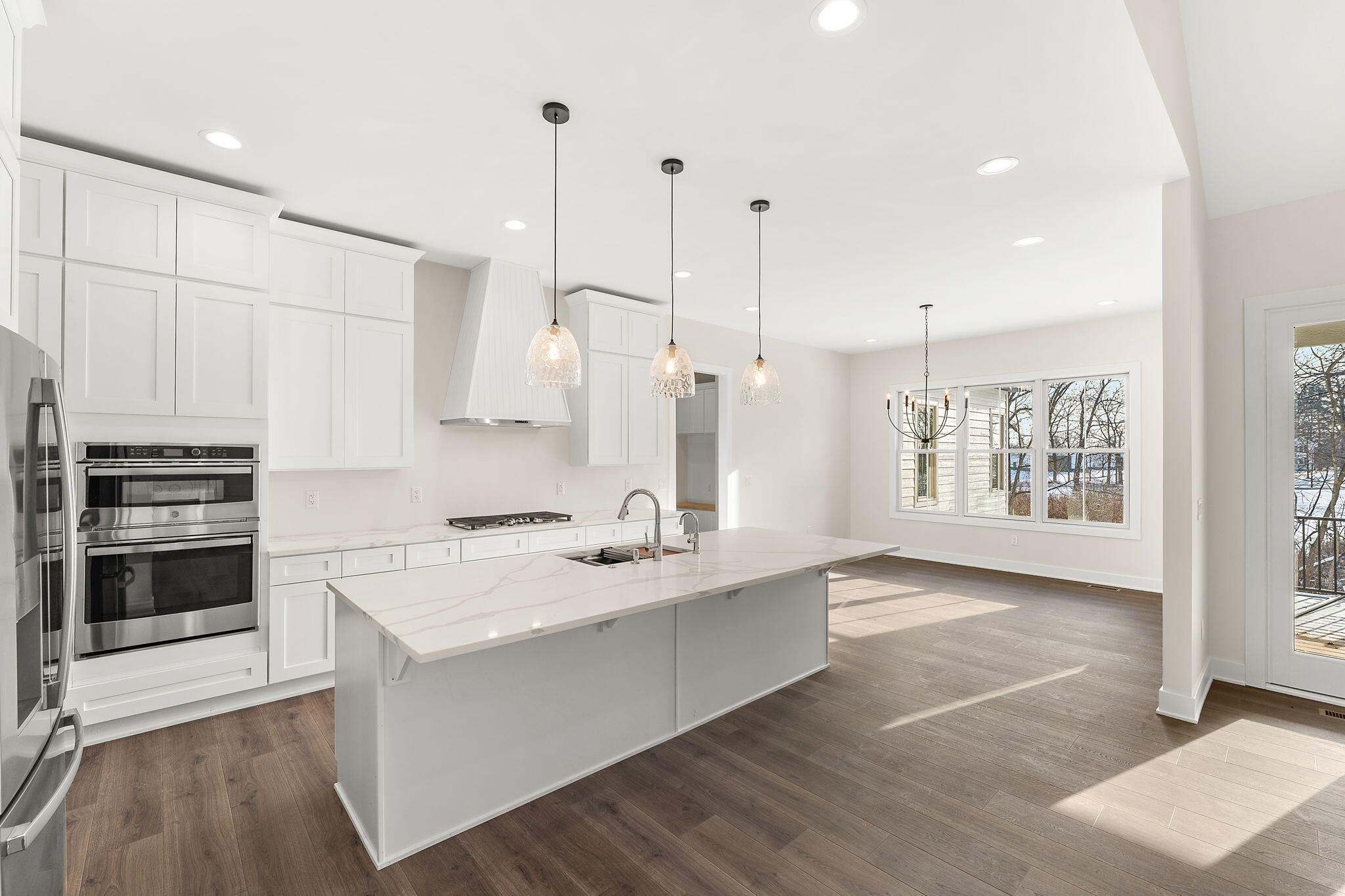 16669 Noble Street Lowell, IN 46356 - Photo 16 of 55 a kitchen with stainless steel appliances granite countertop a stove a sink and a refrigerator
