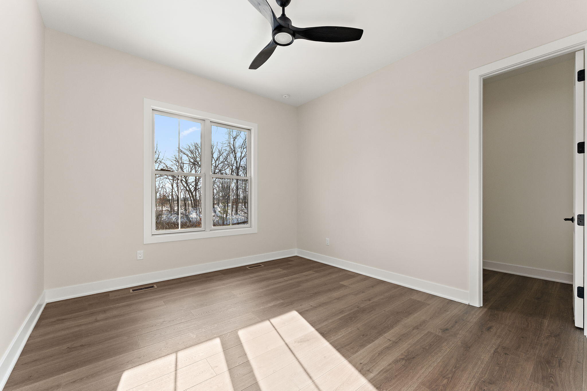 16669 Noble Street Lowell, IN 46356 - Photo 26 of 55 a view of an empty room with wooden floor and a window