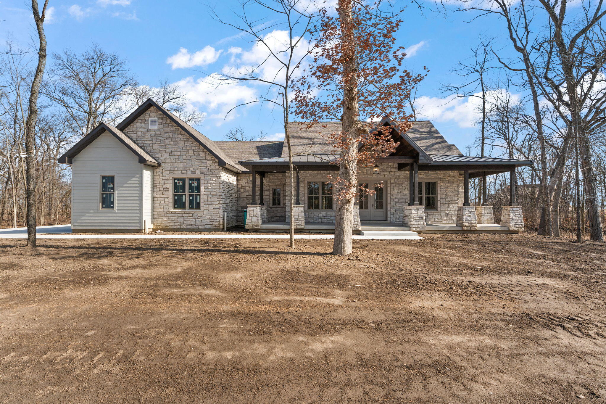 16669 Noble Street Lowell, IN 46356 - Photo 3 of 55 a view of a white house with a large tree and a yard