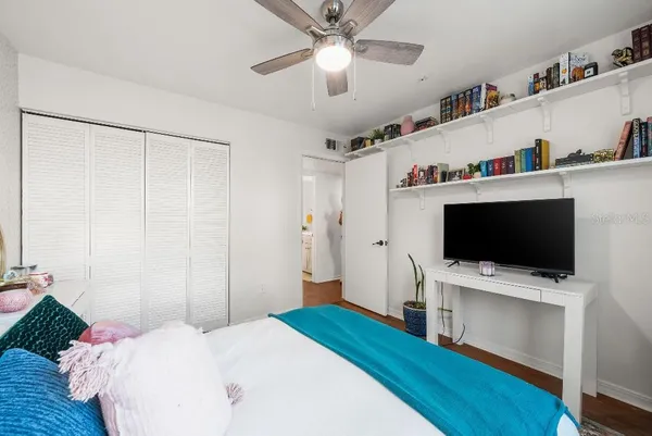a bedroom with a bed and a flat screen tv