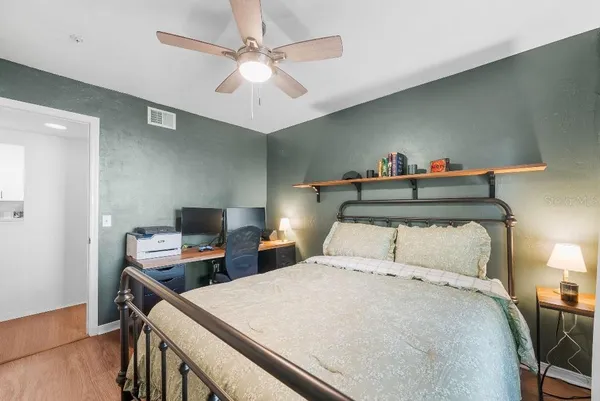 a bedroom with a bed and a chandelier
