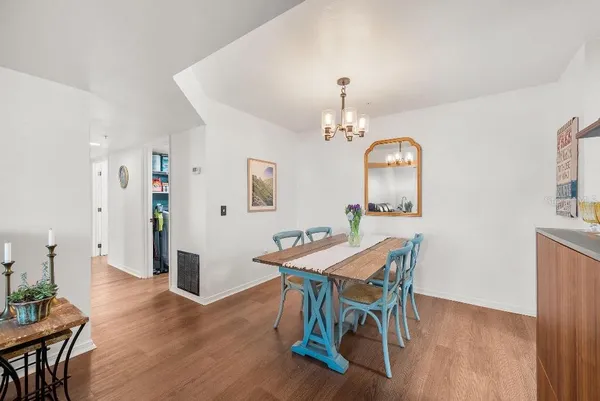 a view of a dining room with furniture and wooden floor