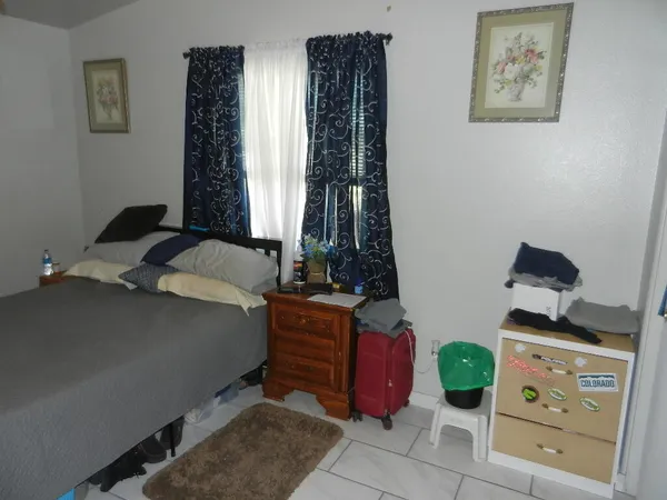 a bedroom with a bed closet and a mirror