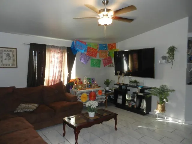 a living room with furniture and a flat screen tv