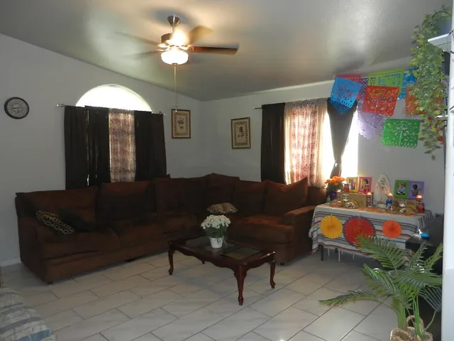 a living room with furniture and a chandelier