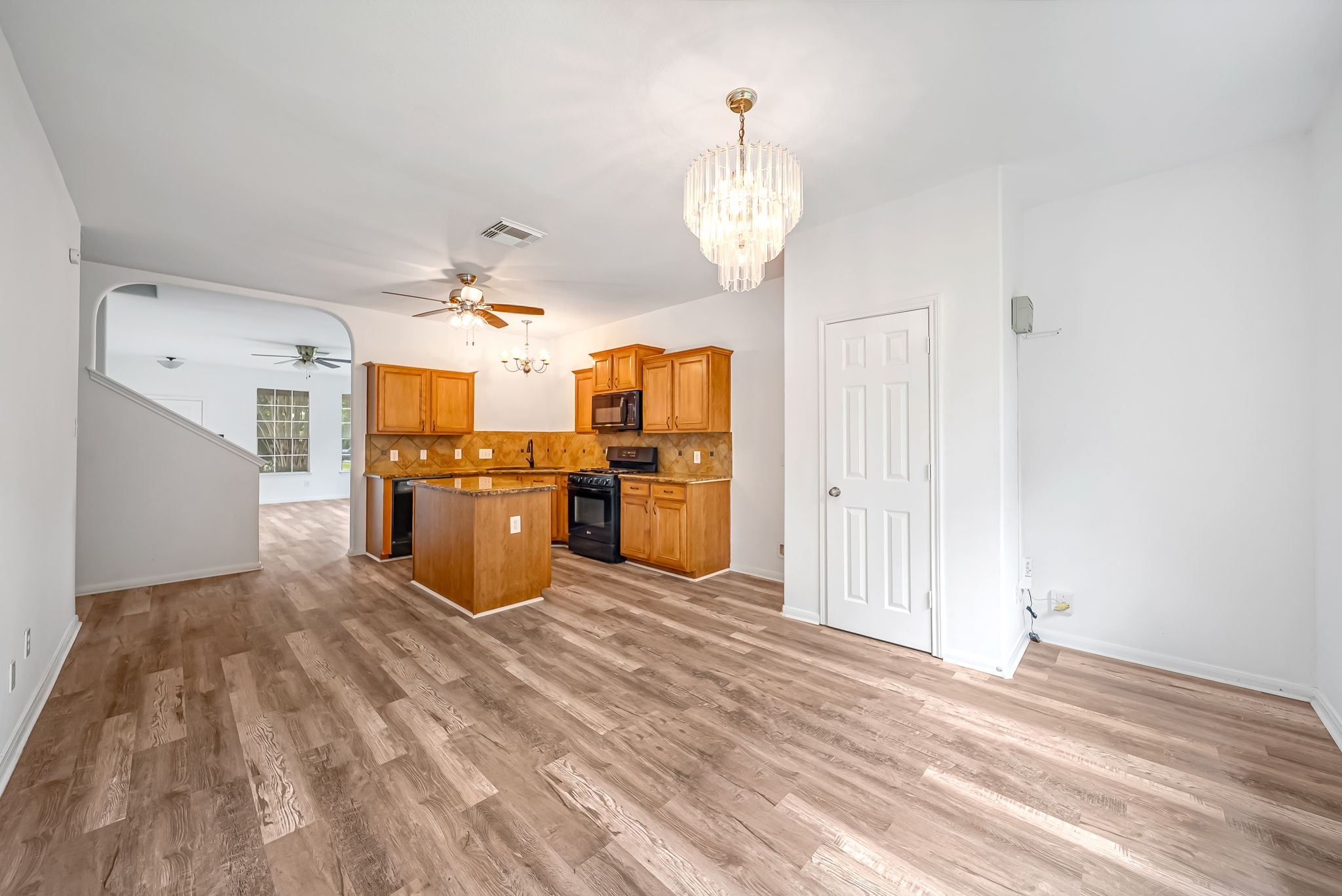 23526 Whispering Maple Drive Spring, TX 77373 - Photo 7 of 26 a large room with chandelier fan and kitchen view
