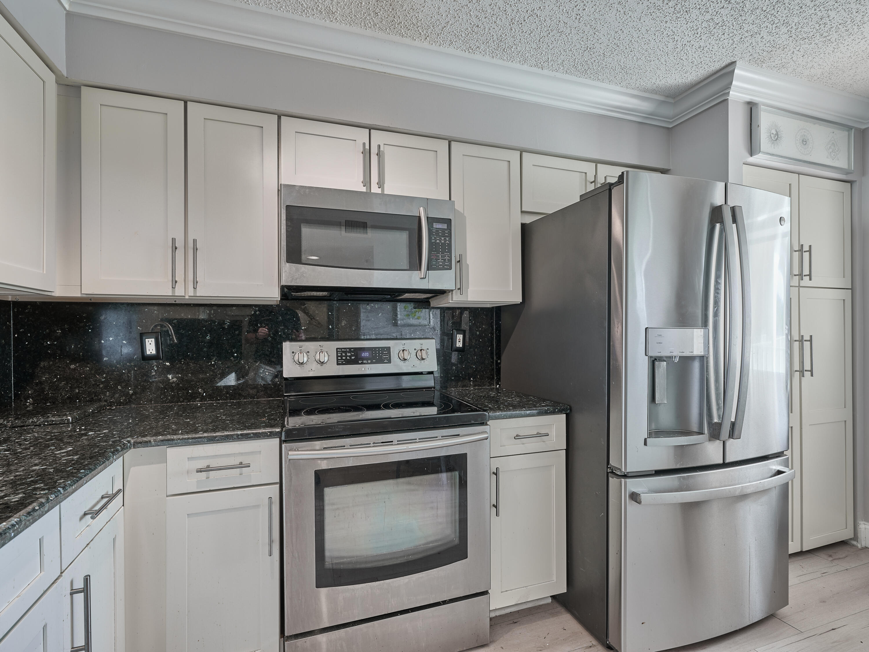 14112 Huntington Pointe Drive, Unit 401 Delray Beach, FL 33484 - Photo 12 of 49 a kitchen with cabinets stainless steel appliances and a counter space