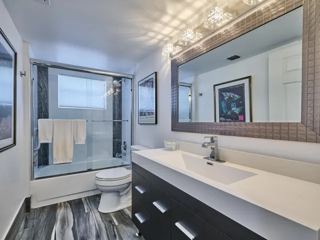 a bathroom with a sink toilet and shower