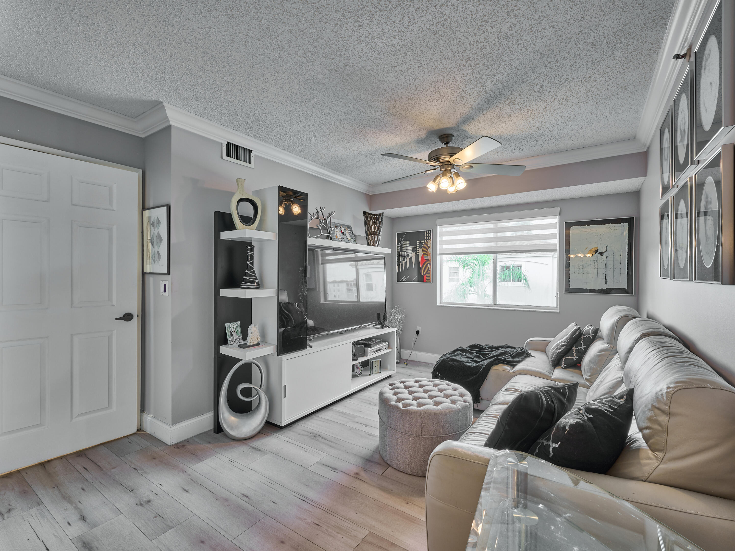 14112 Huntington Pointe Drive, Unit 401 Delray Beach, FL 33484 - Photo 25 of 49 a living room with furniture and a flat screen tv