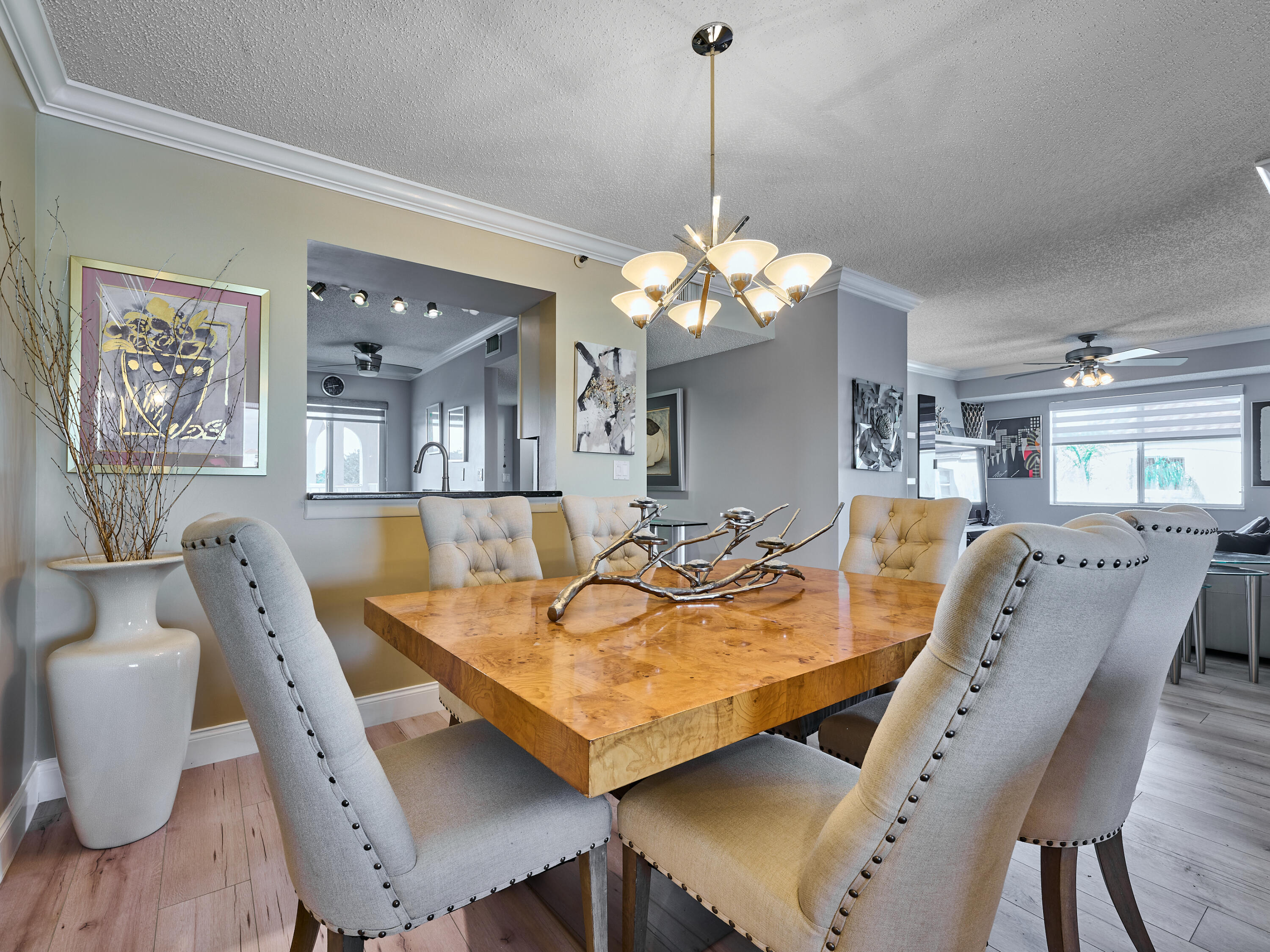 14112 Huntington Pointe Drive, Unit 401 Delray Beach, FL 33484 - Photo 29 of 49 a dining room with furniture a chandelier and wooden floor