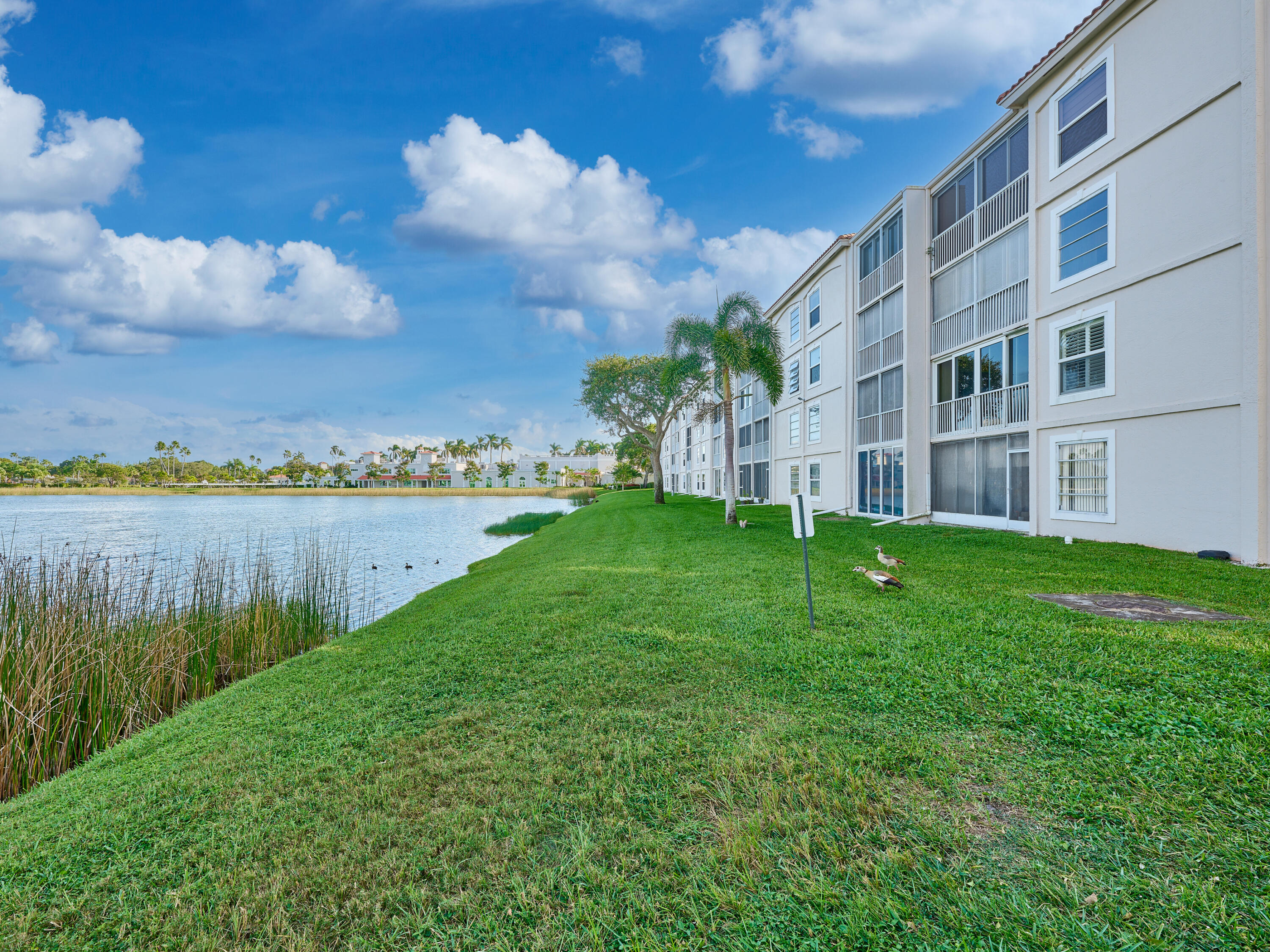 14112 Huntington Pointe Drive, Unit 401 Delray Beach, FL 33484 - Photo 48 of 49 a view of building with garden