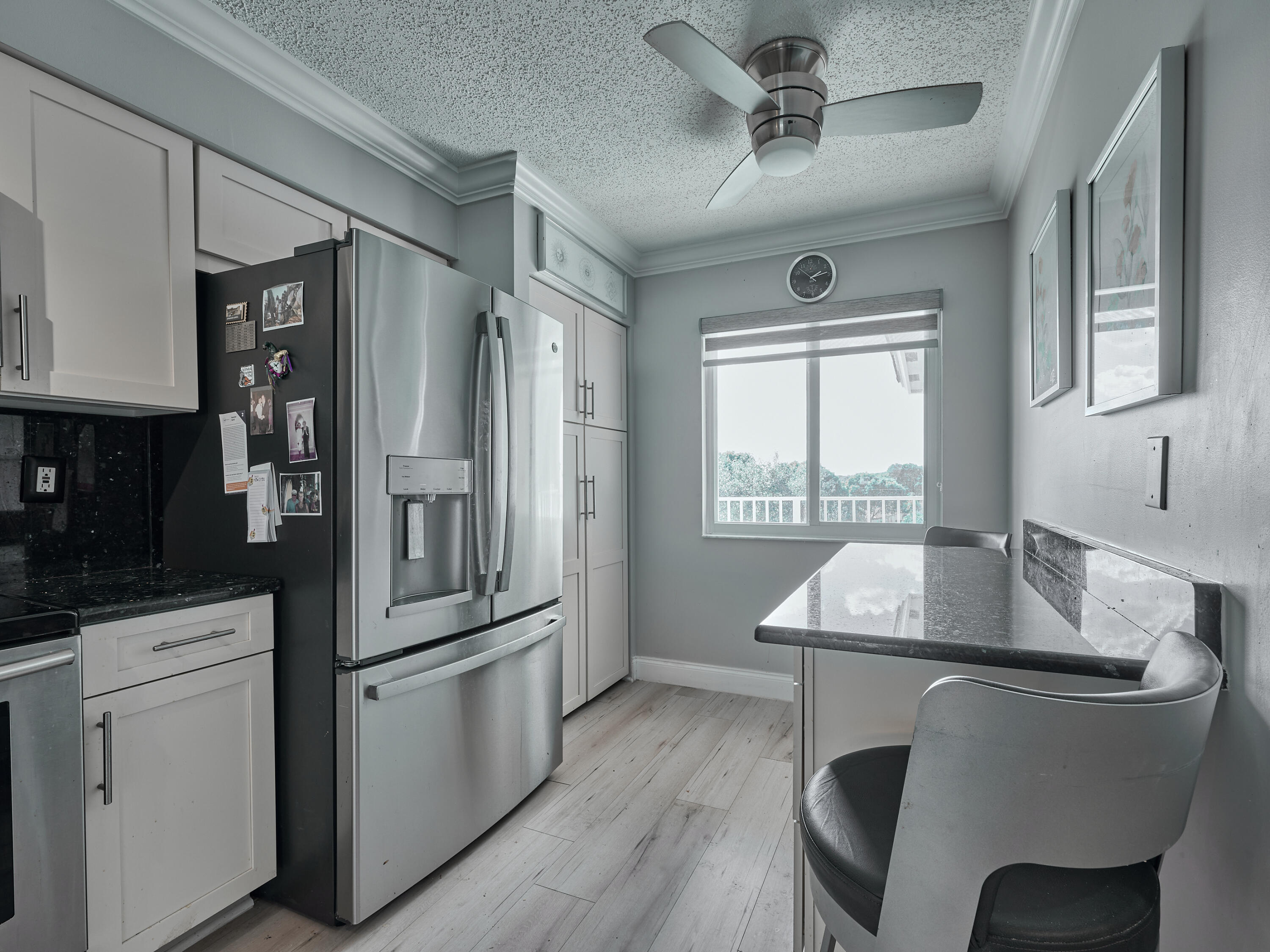 14112 Huntington Pointe Drive, Unit 401 Delray Beach, FL 33484 - Photo 6 of 49 a kitchen with refrigerator cabinets and wooden floor