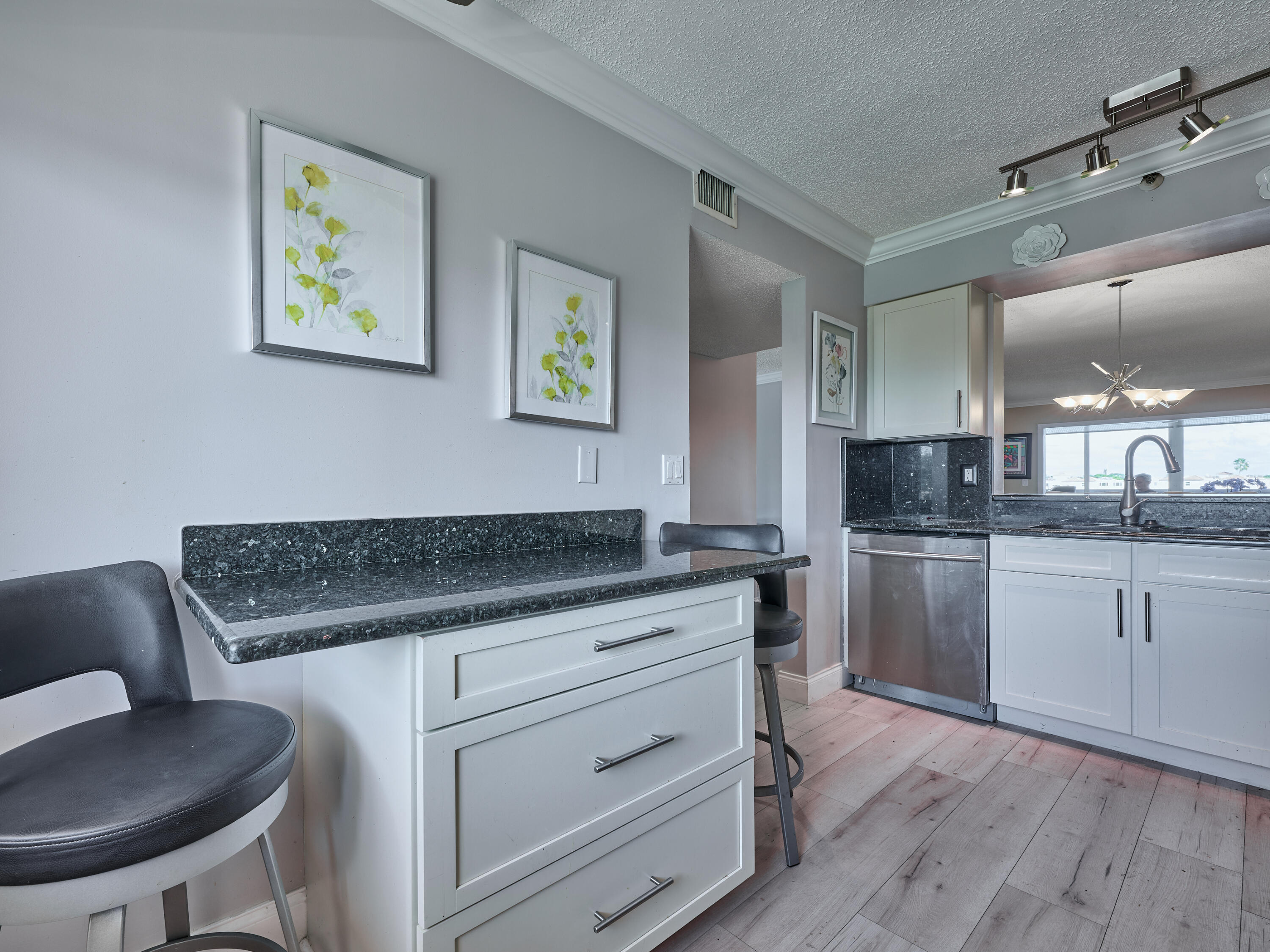 14112 Huntington Pointe Drive, Unit 401 Delray Beach, FL 33484 - Photo 8 of 49 a kitchen with granite countertop a sink cabinets and wooden floor