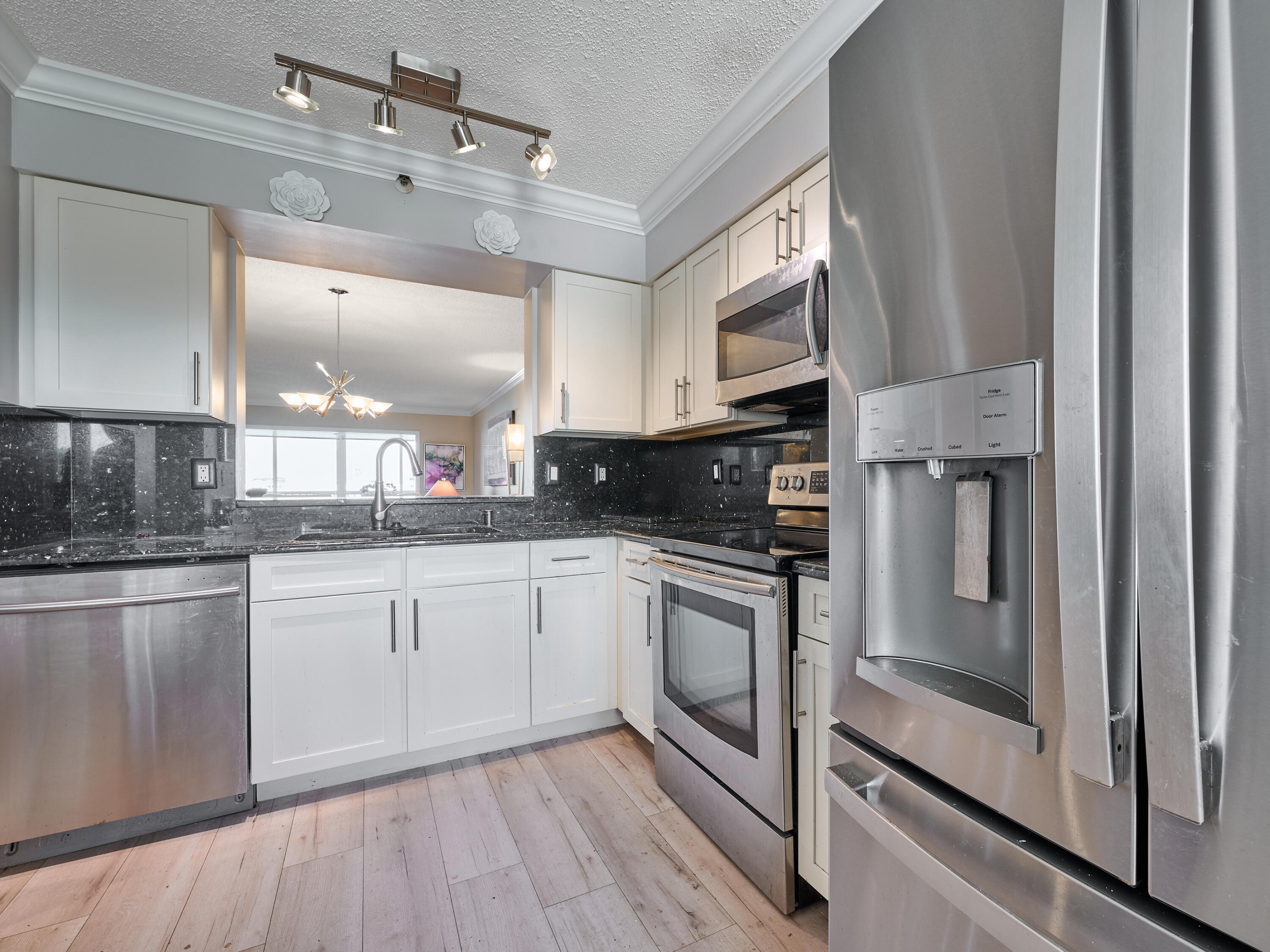 14112 Huntington Pointe Drive, Unit 401 Delray Beach, FL 33484 - Photo 9 of 49 a kitchen with stainless steel appliances granite countertop a stove a sink and a refrigerator