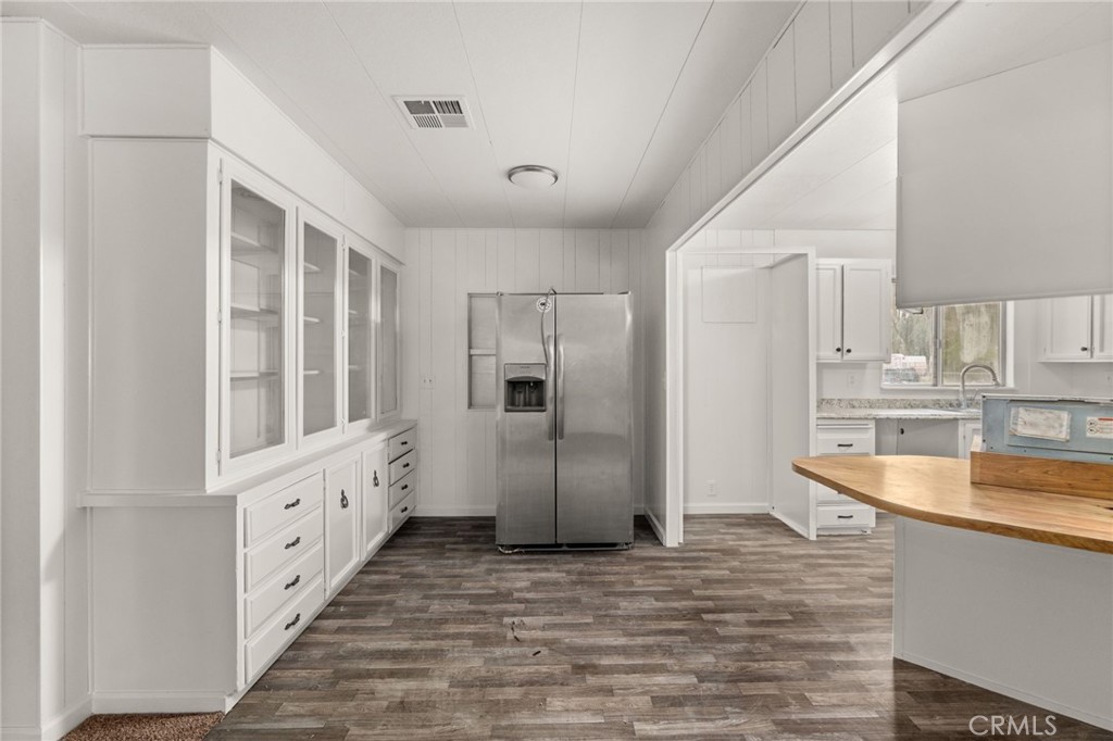 52102 Date Avenue Cabazon, CA 92230 - Photo 13 of 32 a kitchen with white cabinets and refrigerator