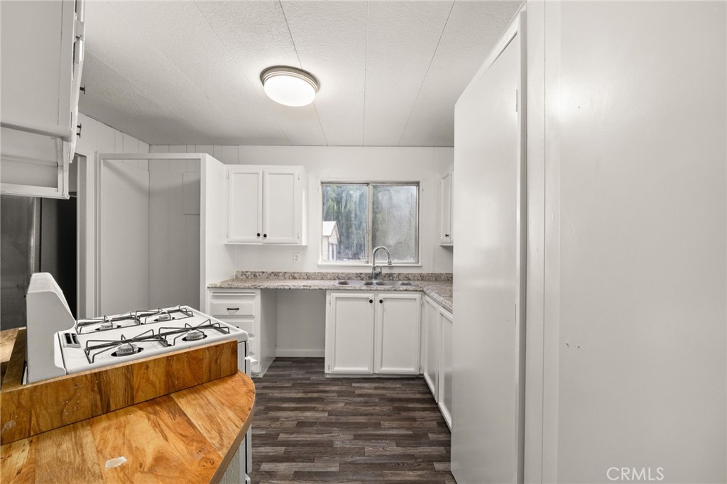 52102 Date Avenue Cabazon, CA 92230 - Photo 17 of 32 a kitchen with kitchen island granite countertop a sink cabinets and stainless steel appliances