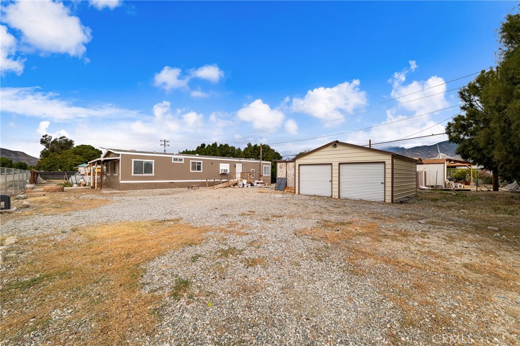 52102 Date Avenue Cabazon, CA 92230 - Photo 30 of 32 a front view of a house with a yard