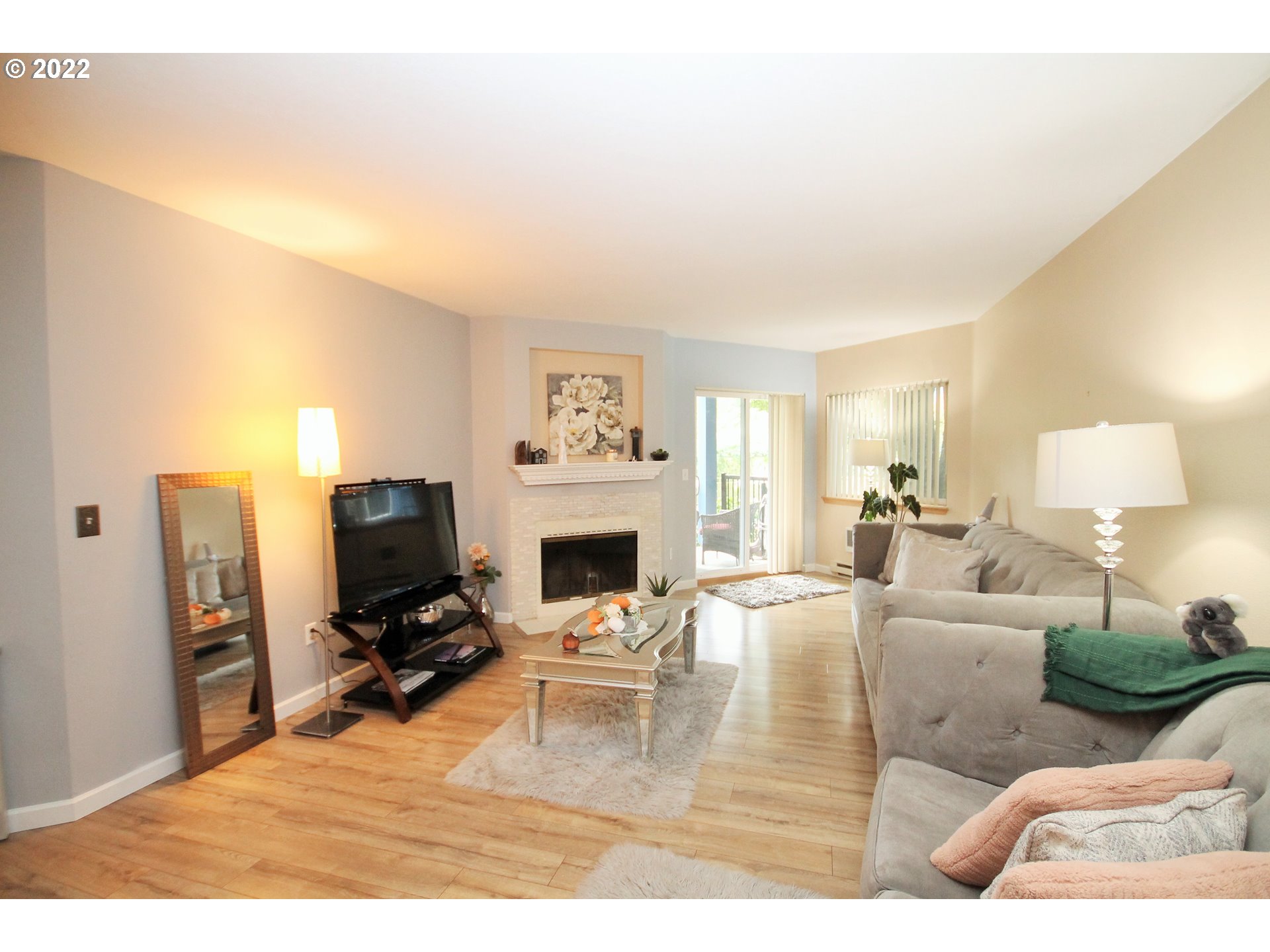 8720 Southwest Tualatin Road, Unit 107 Tualatin, OR 97062 - Photo 11 of 30 a living room with furniture a fireplace and a flat screen tv