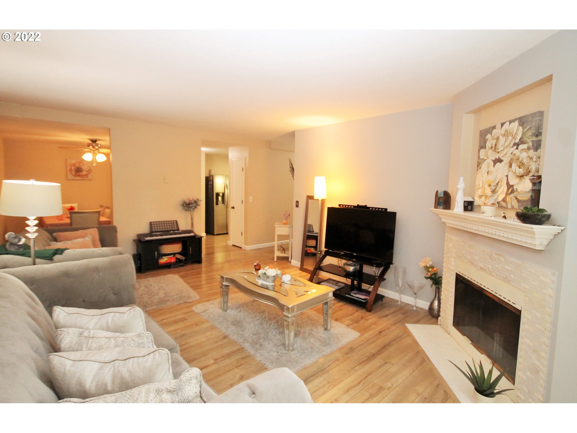 8720 Southwest Tualatin Road, Unit 107 Tualatin, OR 97062 - Photo 13 of 30 a living room with furniture a fireplace and a flat screen tv