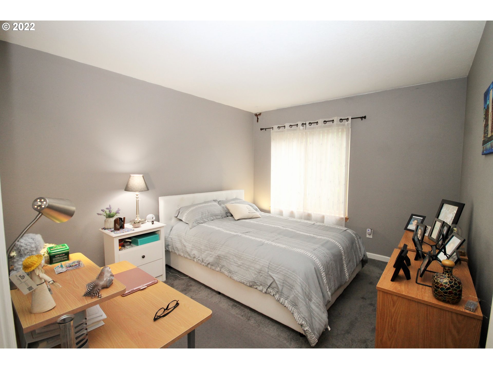 8720 Southwest Tualatin Road, Unit 107 Tualatin, OR 97062 - Photo 17 of 30 a bedroom with a bed and a lamp