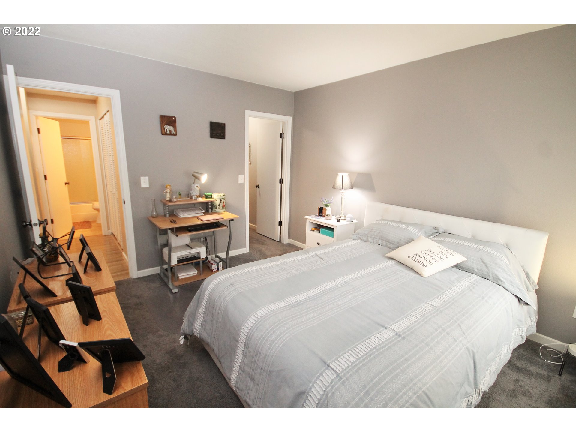 8720 Southwest Tualatin Road, Unit 107 Tualatin, OR 97062 - Photo 18 of 30 a bedroom with a bed and wooden floor