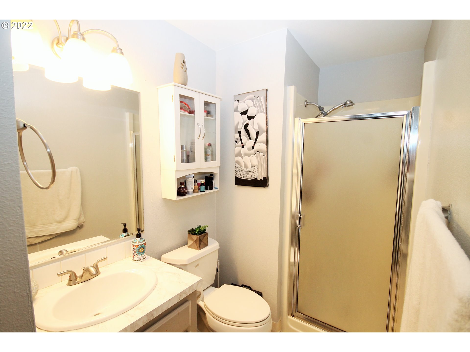 8720 Southwest Tualatin Road, Unit 107 Tualatin, OR 97062 - Photo 21 of 30 a bathroom with a sink a toilet and shower