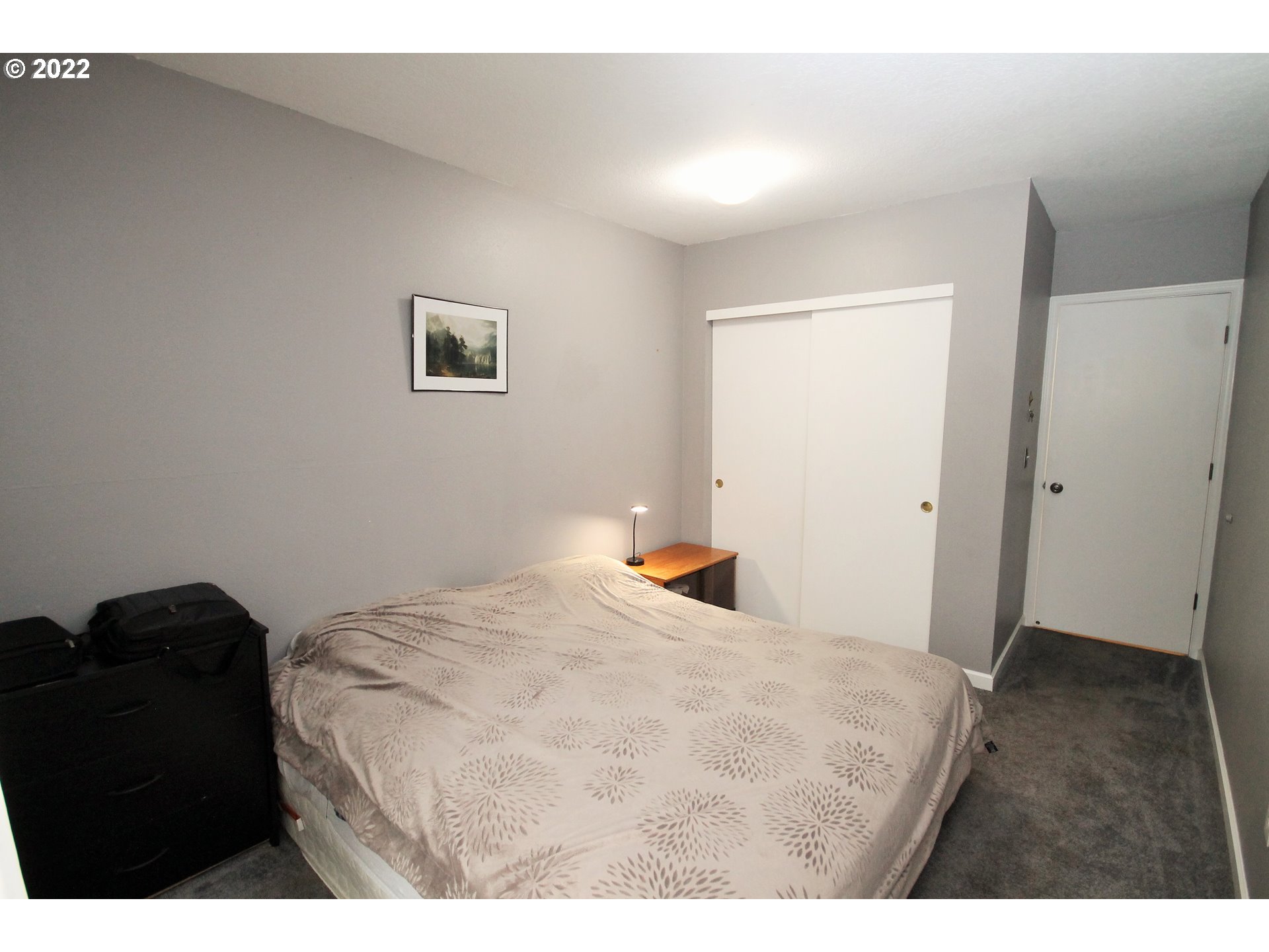 8720 Southwest Tualatin Road, Unit 107 Tualatin, OR 97062 - Photo 23 of 30 a bedroom with a bed and wooden floor