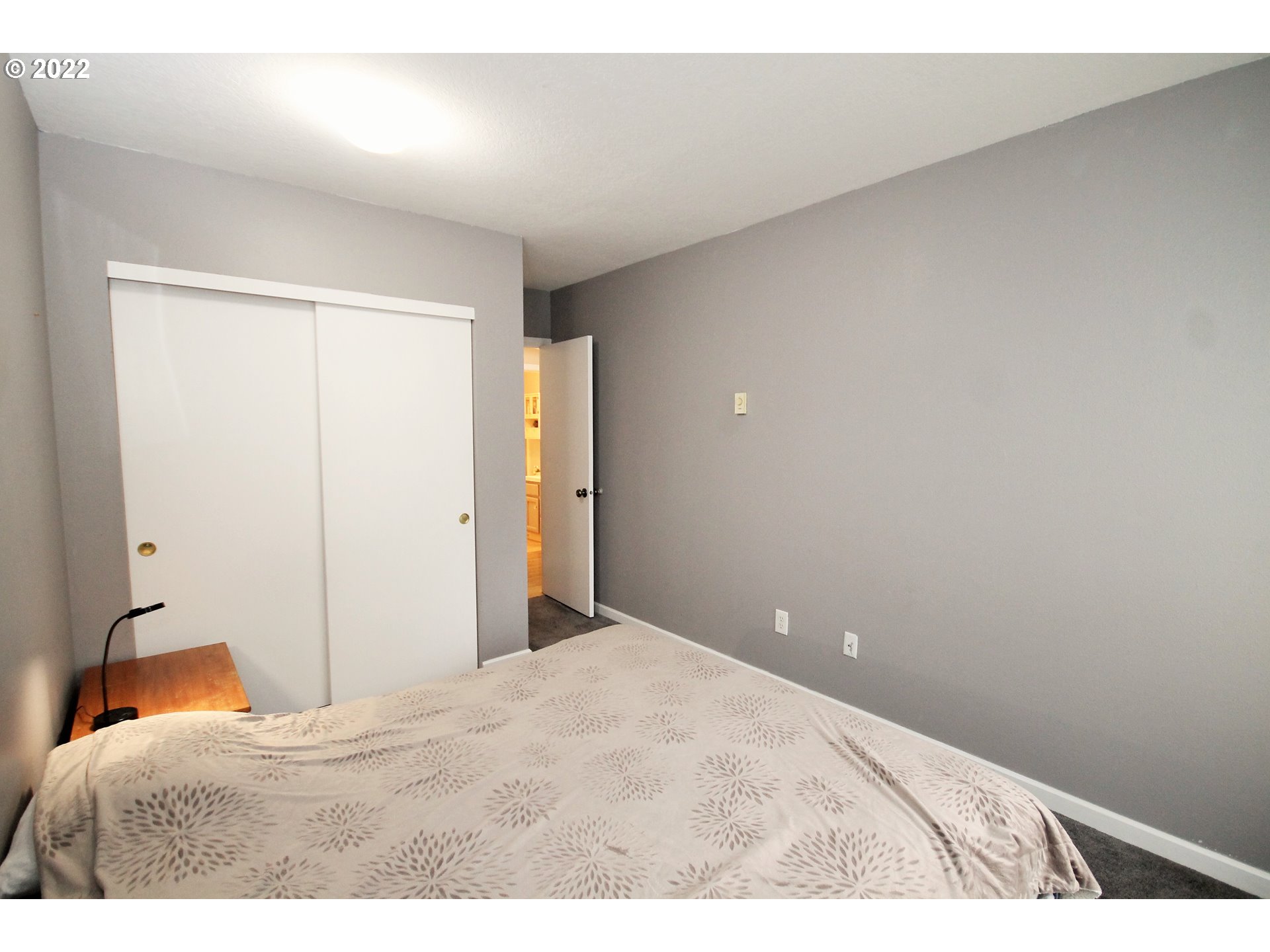 8720 Southwest Tualatin Road, Unit 107 Tualatin, OR 97062 - Photo 24 of 30 a bedroom with a bed and a lamp