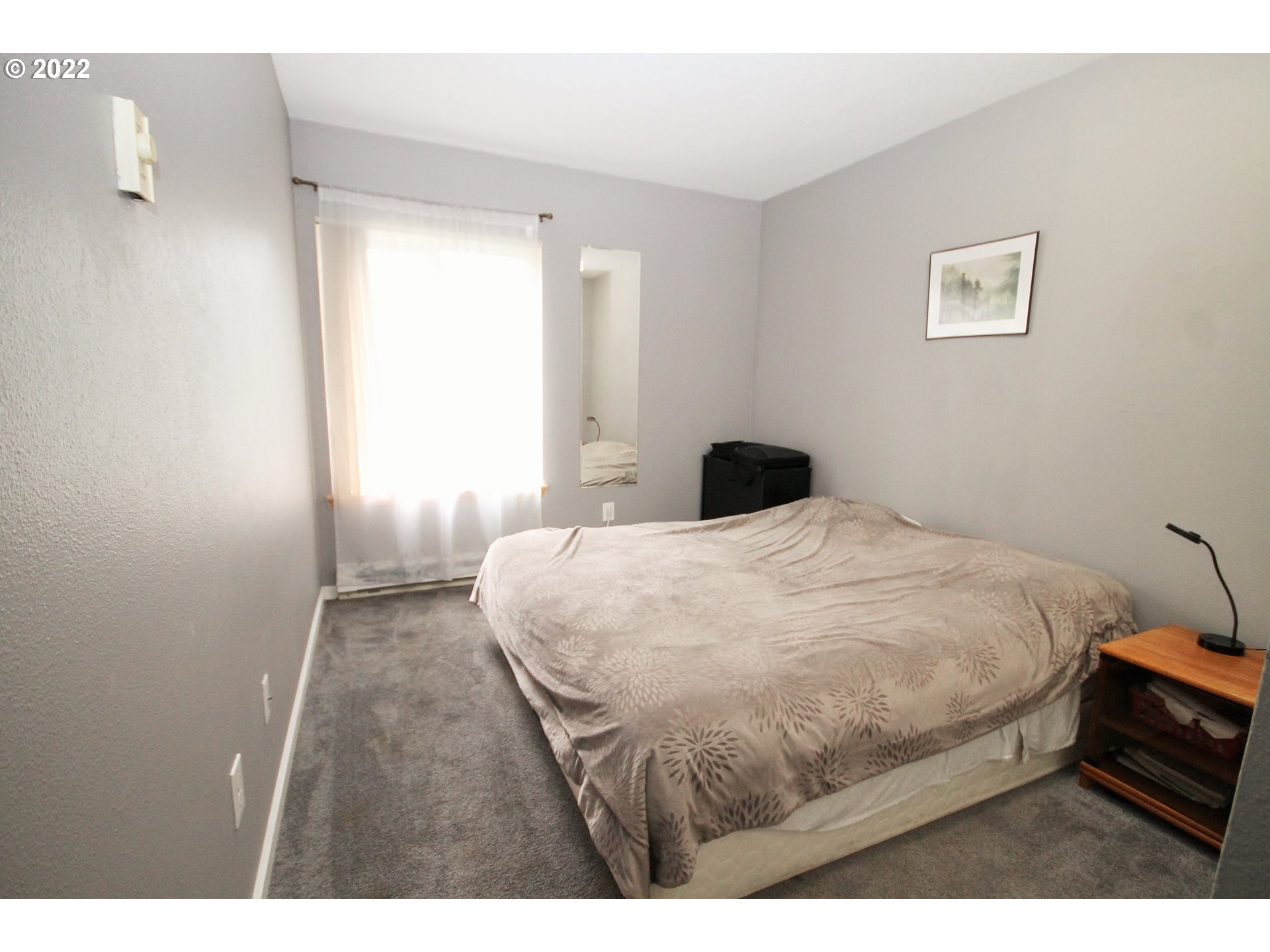 8720 Southwest Tualatin Road, Unit 107 Tualatin, OR 97062 - Photo 25 of 30 a bedroom with a bed and a night stand
