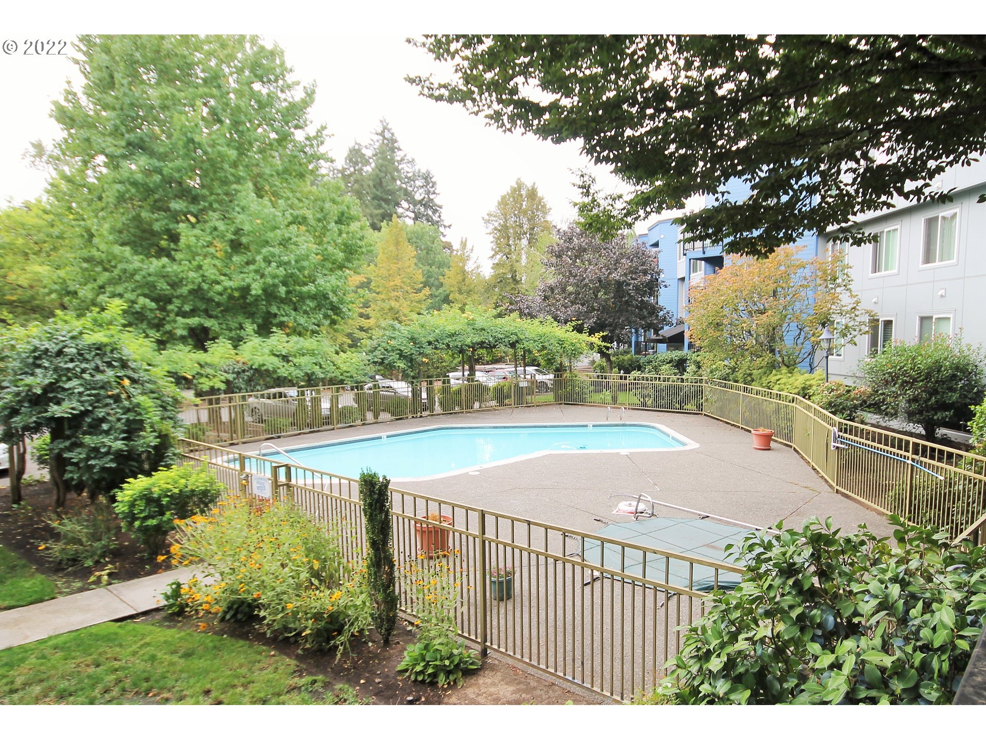 8720 Southwest Tualatin Road, Unit 107 Tualatin, OR 97062 - Photo 27 of 30 a view of a swimming pool with a patio and a yard