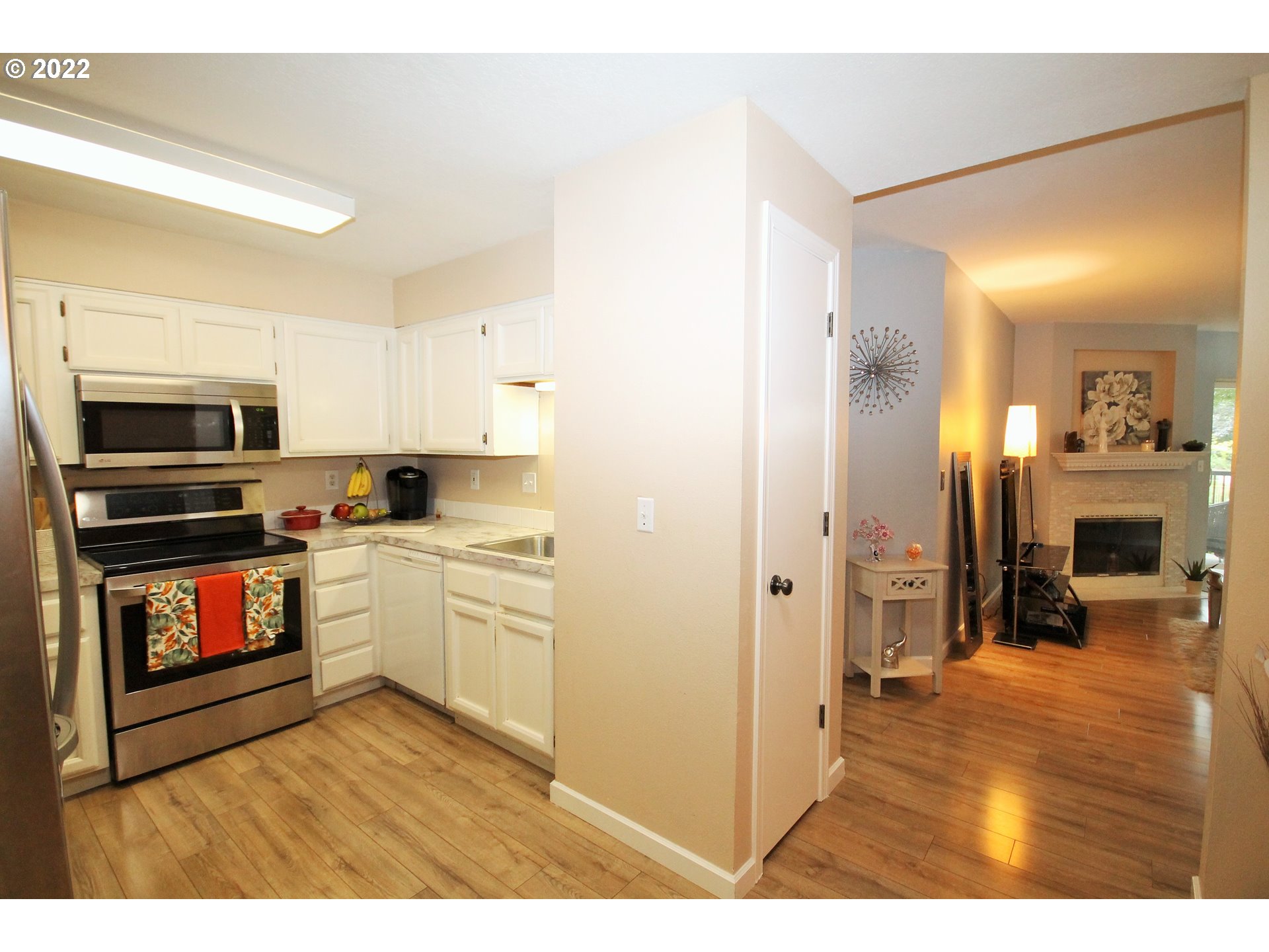 8720 Southwest Tualatin Road, Unit 107 Tualatin, OR 97062 - Photo 5 of 30 a kitchen with cabinets and wooden floor