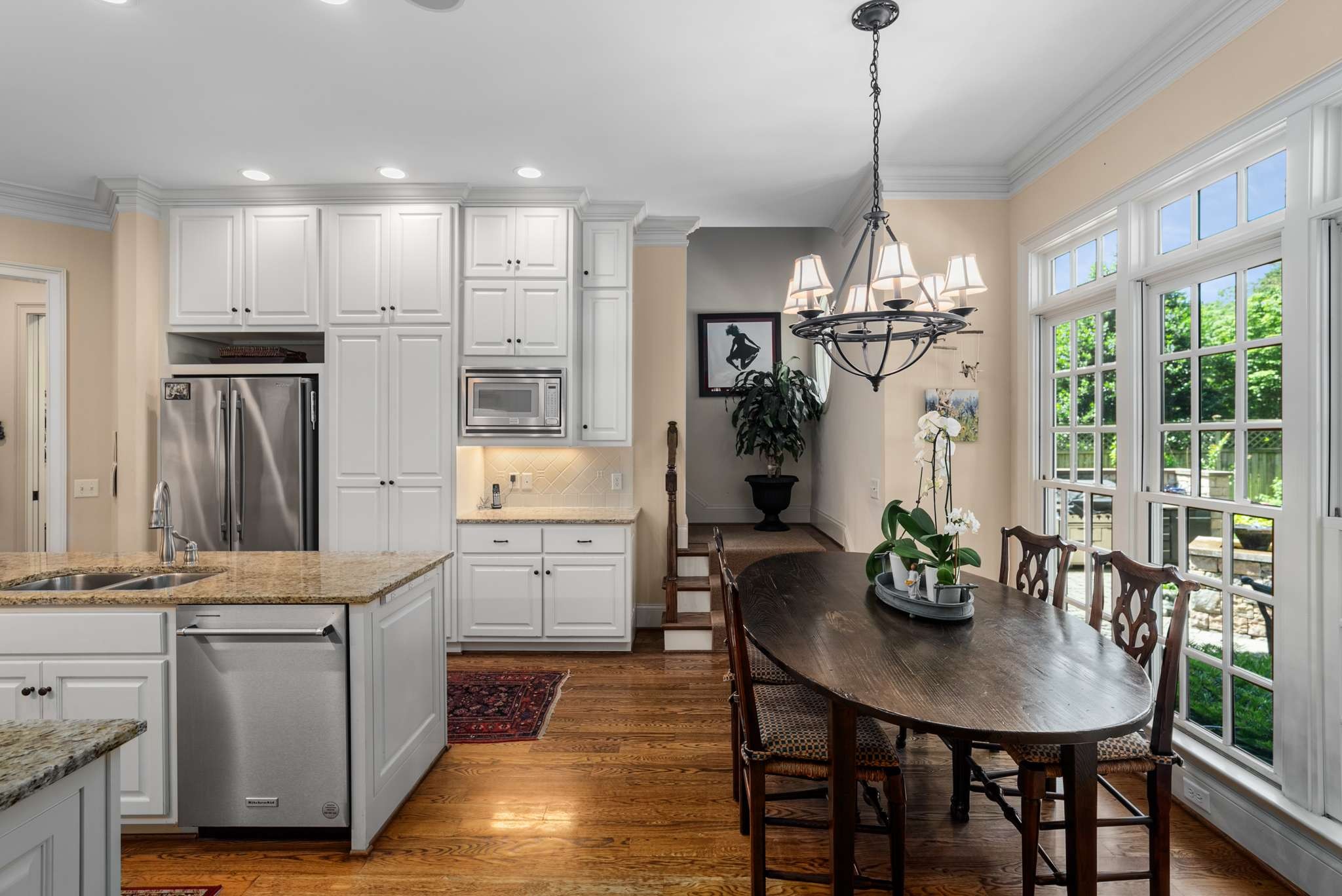 217 Page Road Nashville, TN 37205 - Photo 14 of 61 a kitchen with stainless steel appliances kitchen island granite countertop a table chairs and a refrigerator