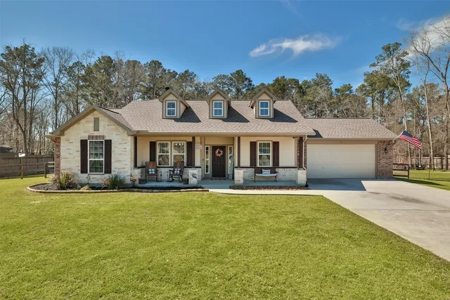 a front view of a house with swimming pool having outdoor seating