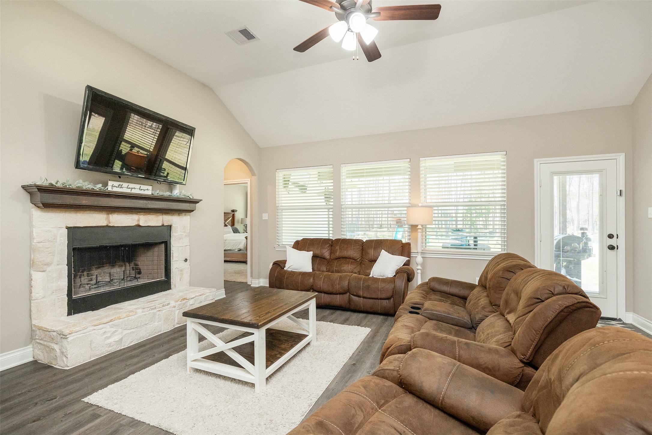 27627 Concho Drive Splendora, TX 77372 - Photo 13 of 41 a living room with furniture a large window and a fireplace