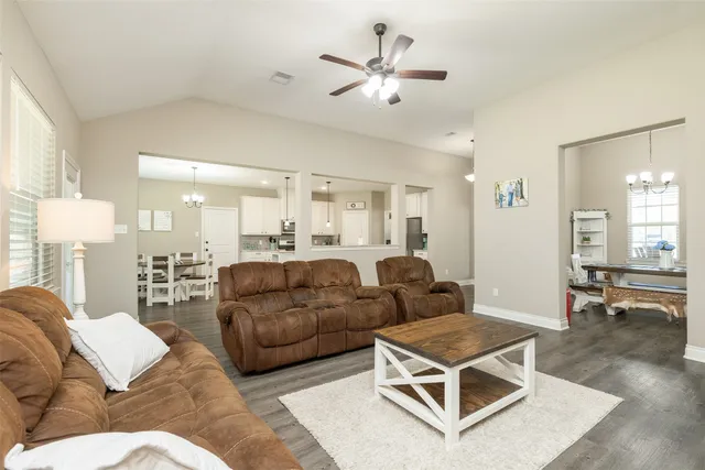 a living room with furniture gym equipment and a chandelier