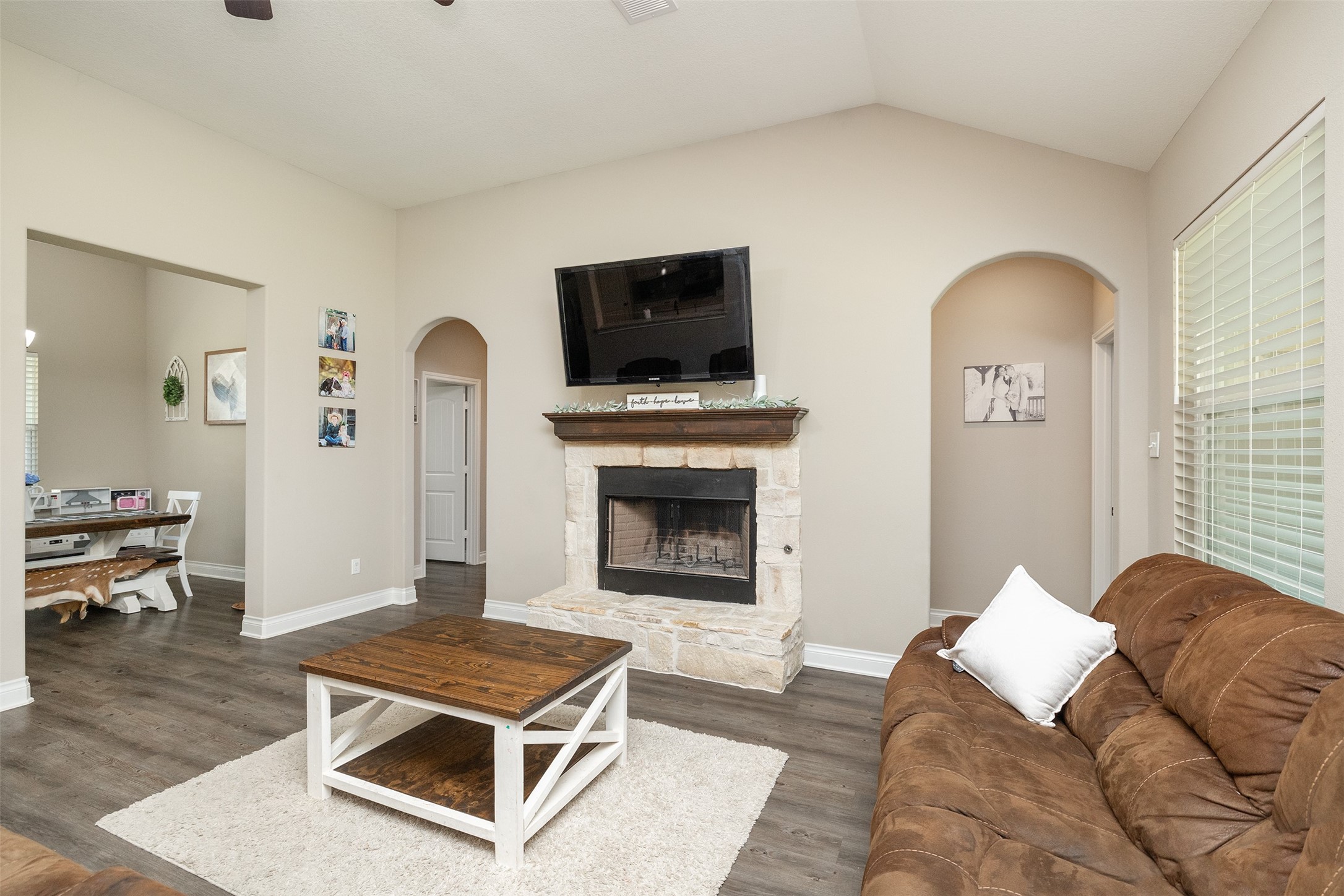 27627 Concho Drive Splendora, TX 77372 - Photo 17 of 41 a living room with furniture a flat screen tv and a fireplace