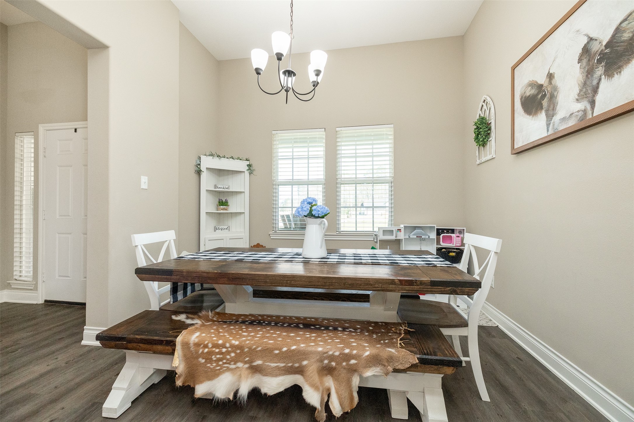 27627 Concho Drive Splendora, TX 77372 - Photo 18 of 41 a bed room with a table chairs and wooden floor