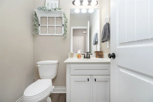a bathroom with a toilet a sink and mirror