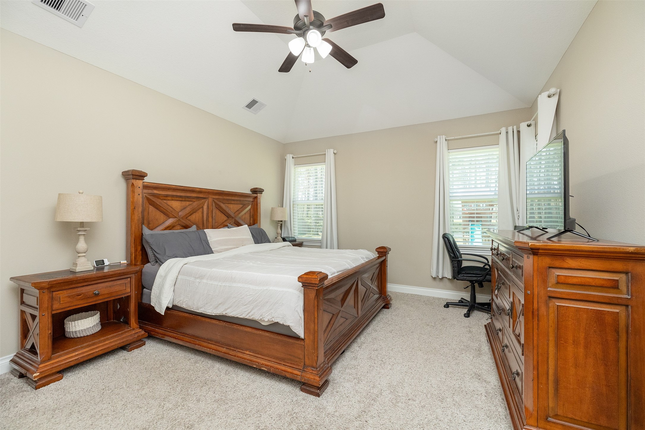 27627 Concho Drive Splendora, TX 77372 - Photo 21 of 41 a bedroom with a bed and a chandelier