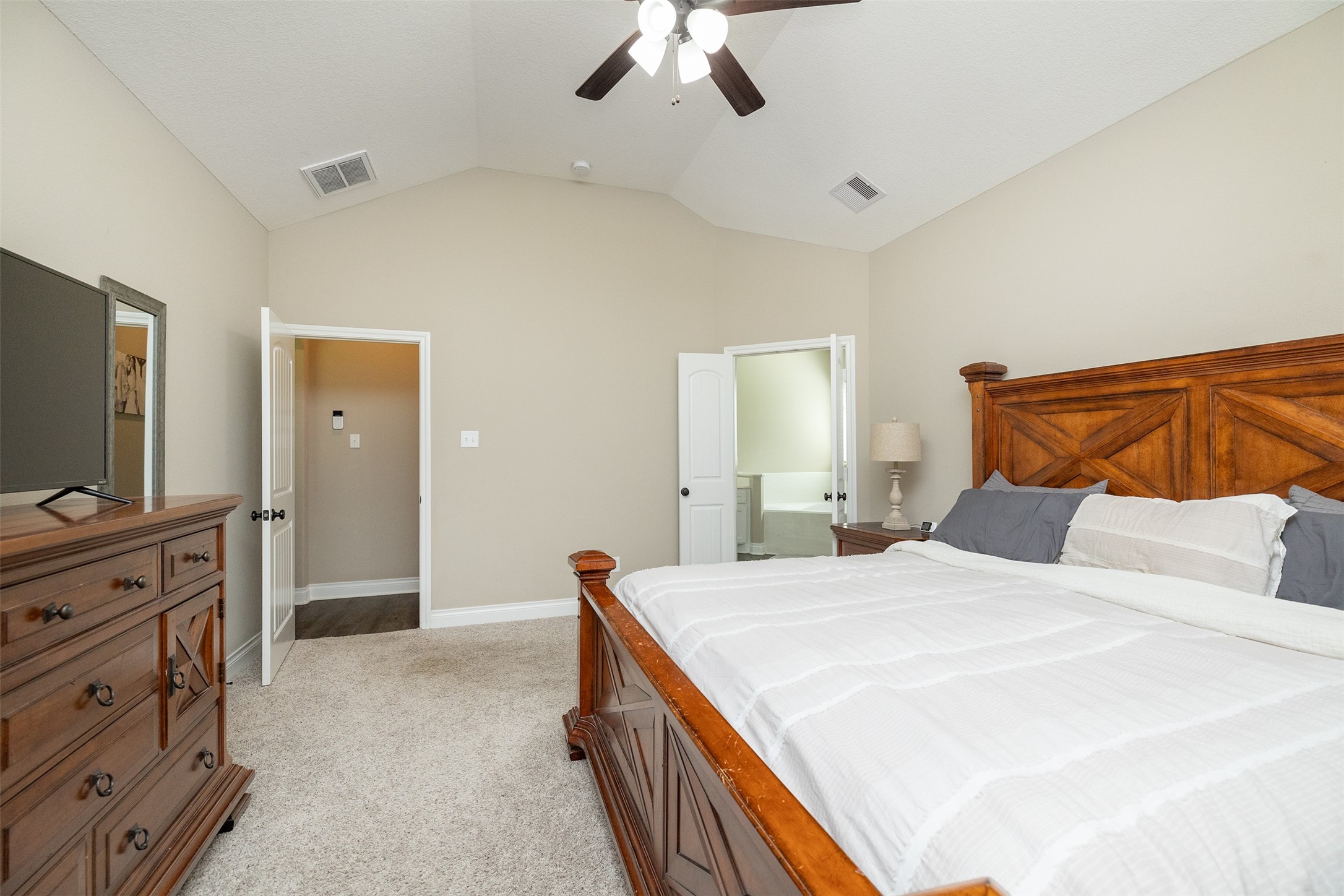 27627 Concho Drive Splendora, TX 77372 - Photo 22 of 41 a bedroom with a bed and a chandelier