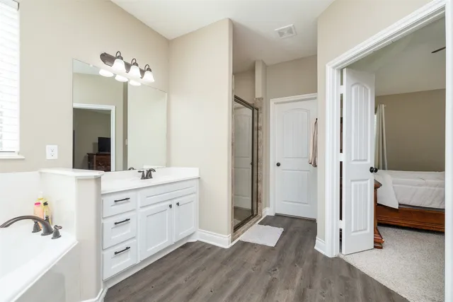 a bathroom with a double vanity sink a mirror and a shower