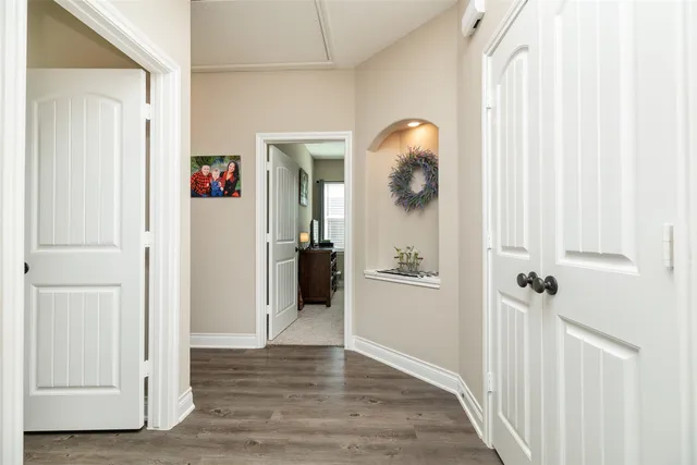 a view of a hallway with wooden floor