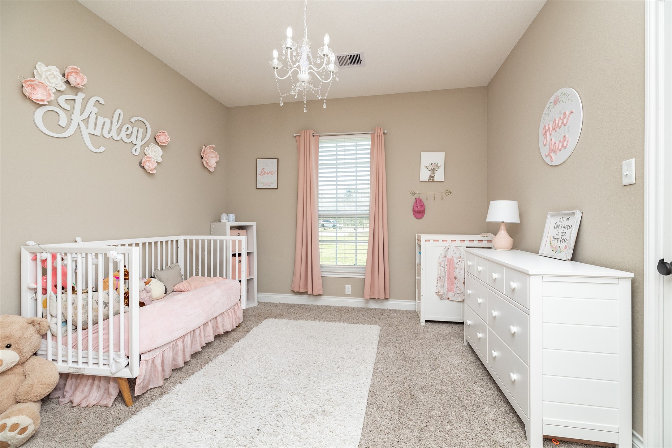27627 Concho Drive Splendora, TX 77372 - Photo 27 of 41 a spacious bedroom with a bed and a chandelier