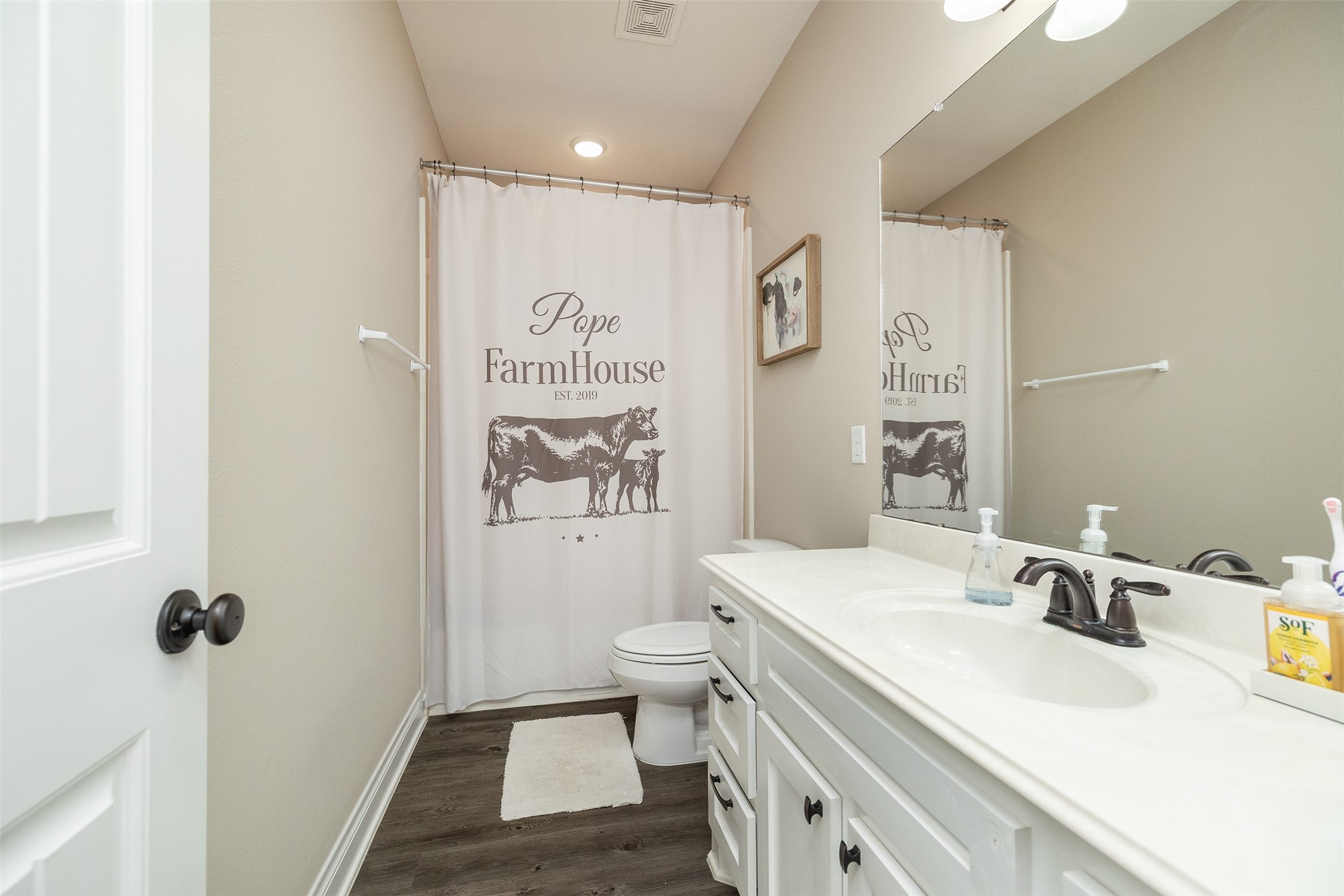 27627 Concho Drive Splendora, TX 77372 - Photo 28 of 41 a bathroom with a sink a toilet and shower curtain
