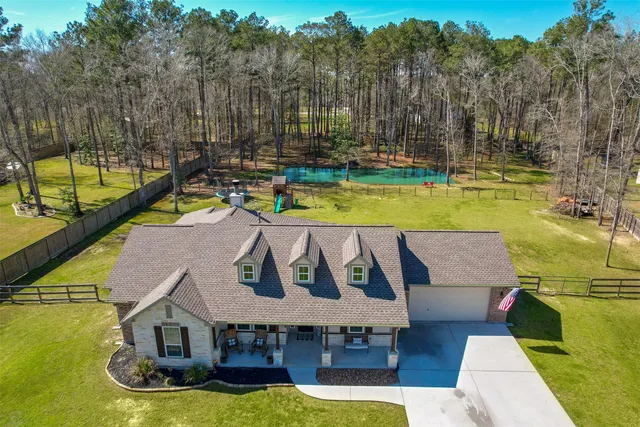 a view of a swimming pool with a patio and a yard