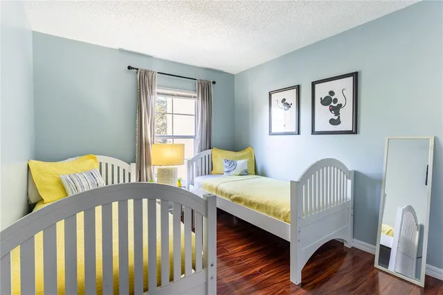 a bedroom with two beds and a window